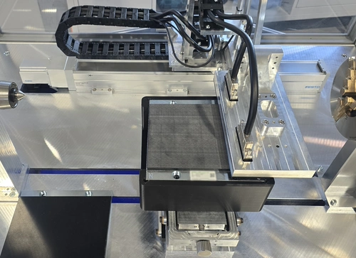Flat sensor array above a linear motor magnet track on the test bench.