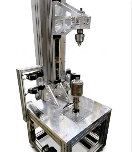 Koob inline test station with a vertical rotor fixture on an aluminium frame.